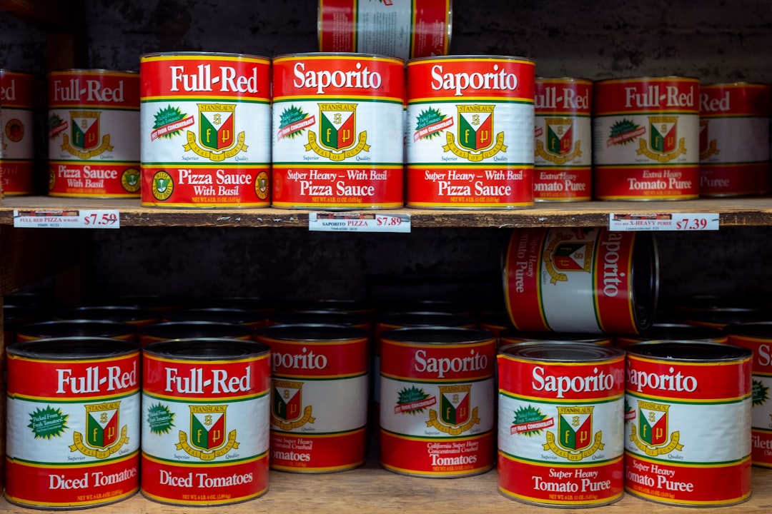 Side-by-side comparison: a normal flat can next to a bulging one